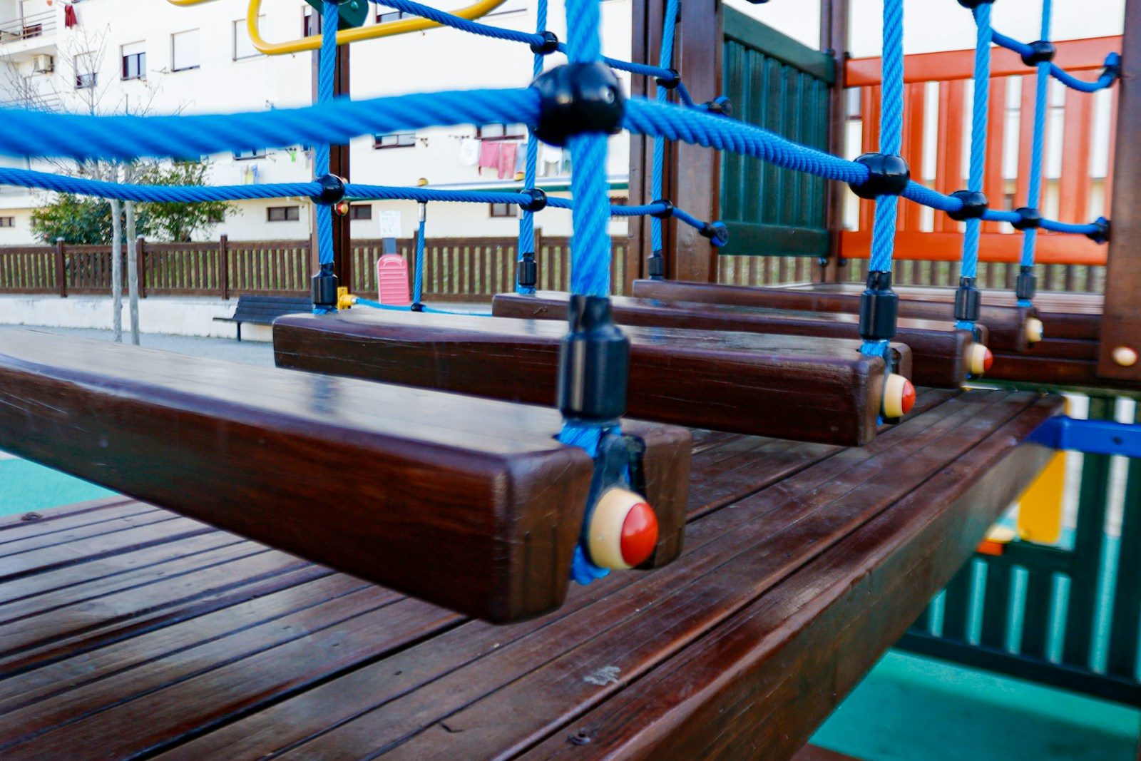 a close up of a wooden bench with ropes on it